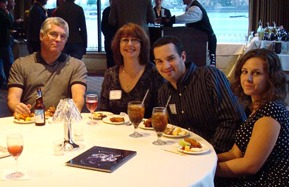 four people seated at a table with food and drinks