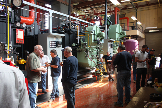 employees standing in the boiler room