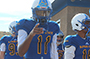 football player with helmet on pointing finger at camera