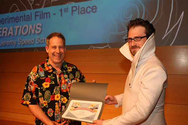 Jeremy Speed Schwartz, right, receives his award for first place from Animator Robert Lyons