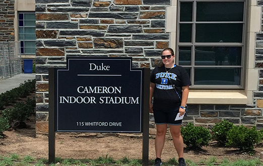 sport management major Kiana Sleight next to Duke stadium sign