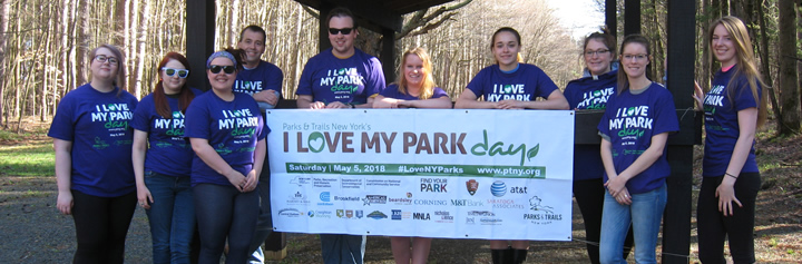 students holding a sign that says I love my park day