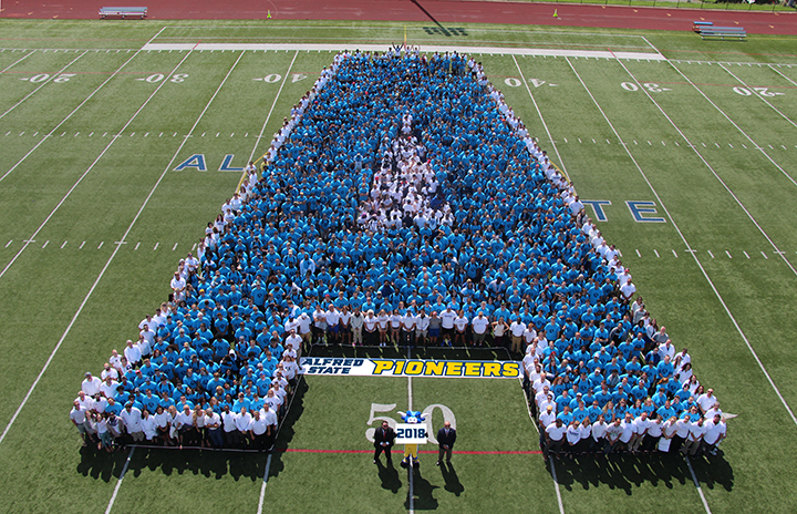 Students, faculty, and staff create a human Alfred State College logo