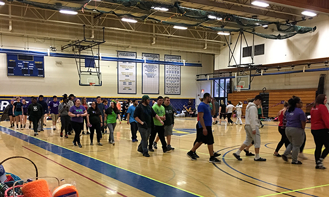 several people walking in the gymnasium