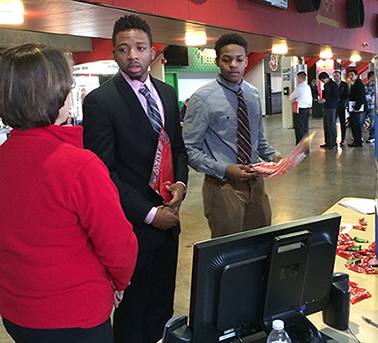 students Samuel Volmy, of Lockport, left, and Justin Wallace, of Mount Vernon, speak with a representative from iHeart Radio