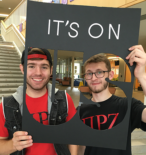 Tyler Ribble, business administration, Elmira, left, and Adam Johnson, architecture, Williamson, pose with an “It’s On Us” cut-out sign