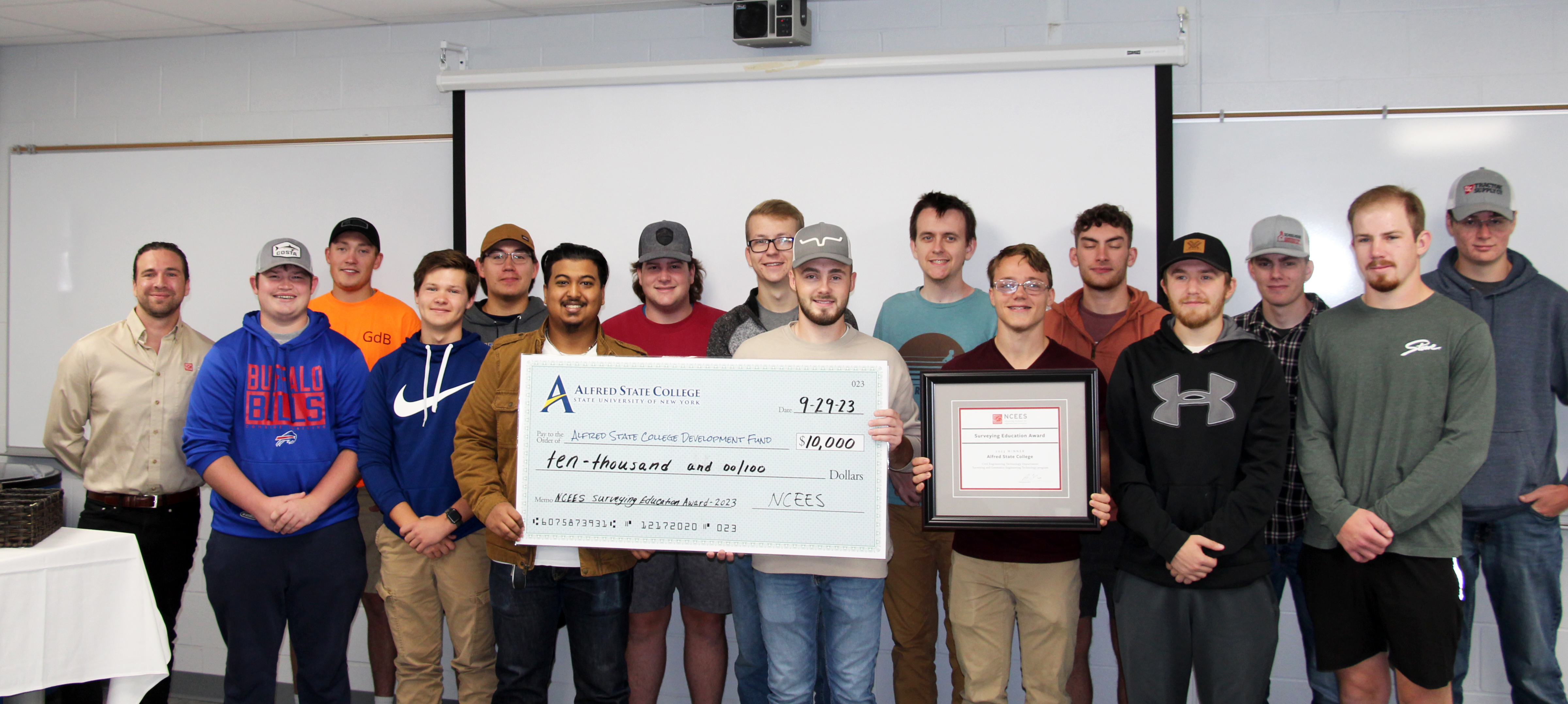 Students pose with the winning check and plaque