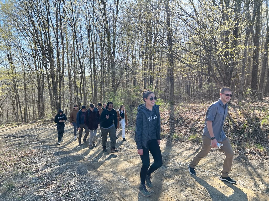 Alfred State students take part in a trail walk on campus.