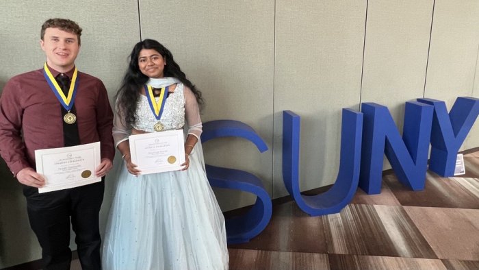 Soumya Konar and Noah Bastedo pose near the SUNY sign after receiving the Chancellor’s Award for Student Excellence in a ceremony held in Albany.