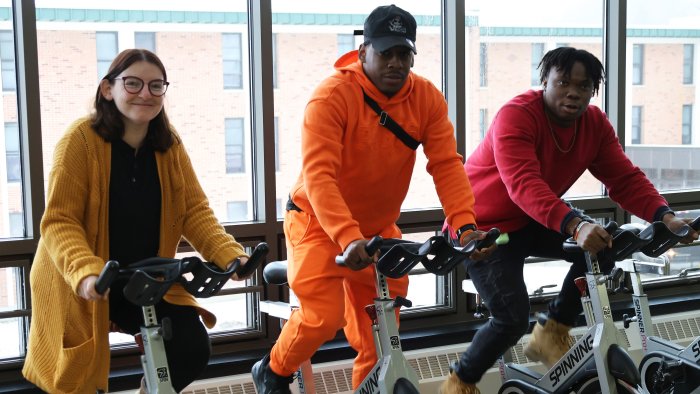 People riding spin bikes