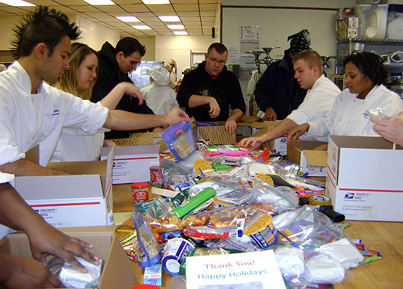 Students pack Christmas boxes for distribution to soldiers