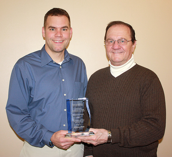 Lawrence and Tezak holding award