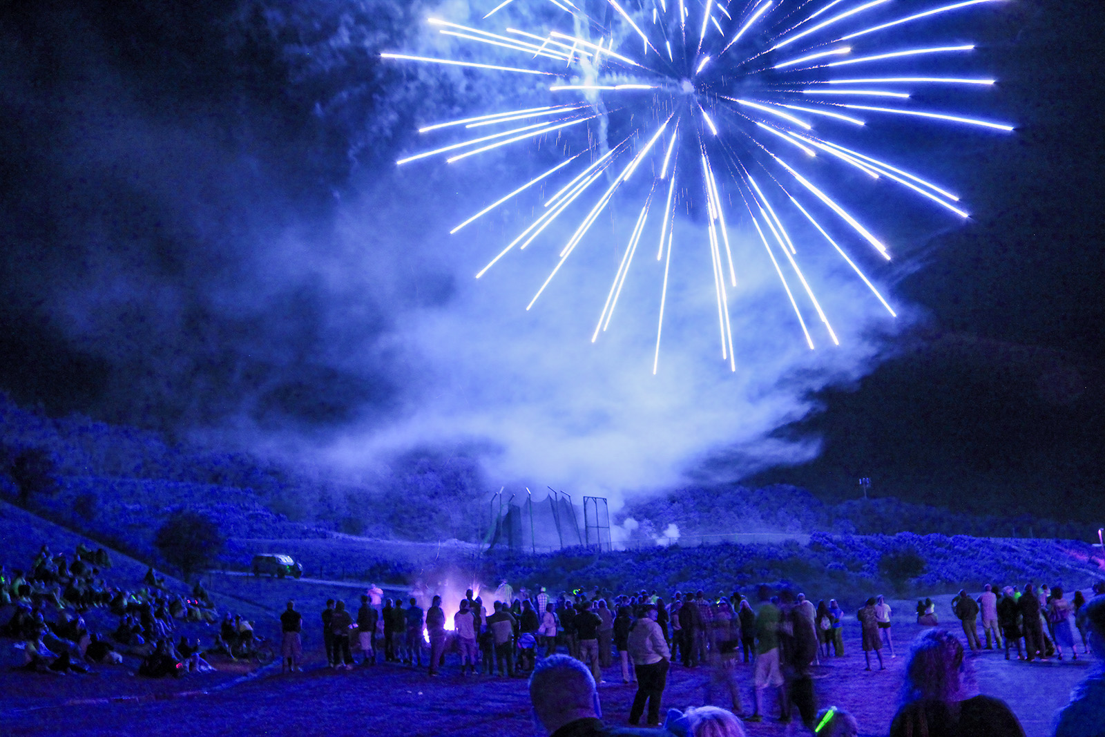 Alfred State at night with fireworks and a bonfire