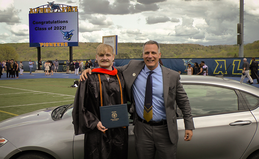 Thomas Nelson poses with his new car and ASC President Dr. Steven Mauro