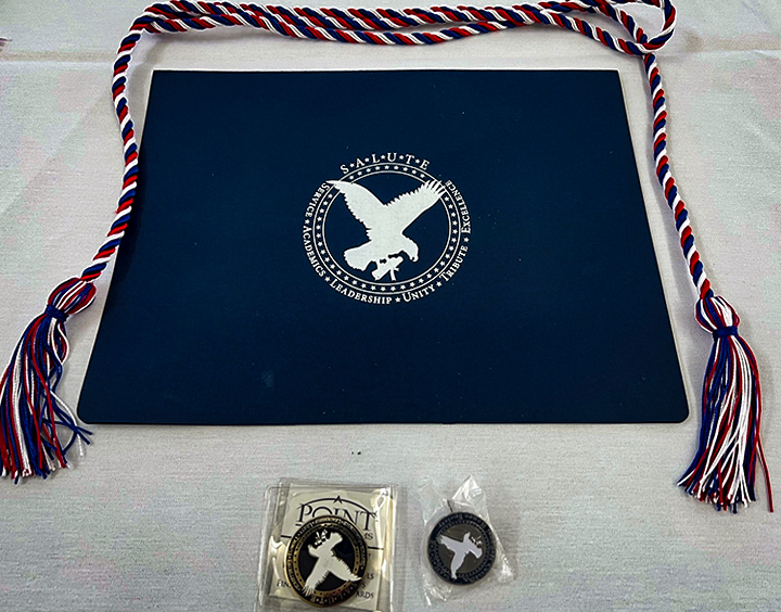 Certificate, honor cords, SALUTE pin, and challenge coin each inductee received.