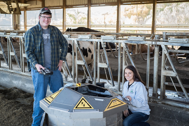 Two students work at the college farm