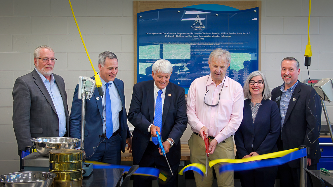 1977 Alfred State graduates Jimmy Smith and Gary Hill cut the ribbon for the Doc Bruce Construction Materials Laboratory. Joining them from left to right, Interim Vice President for Academic Affairs Dr. Craig Clark, ASC President Steven Mauro, Smith, Hill, Department Chair and Professor in the Civil Engineering Technology Department Erin Vitale, and Dean of the School of Architecture, Management & Engineering Technology John Williams.