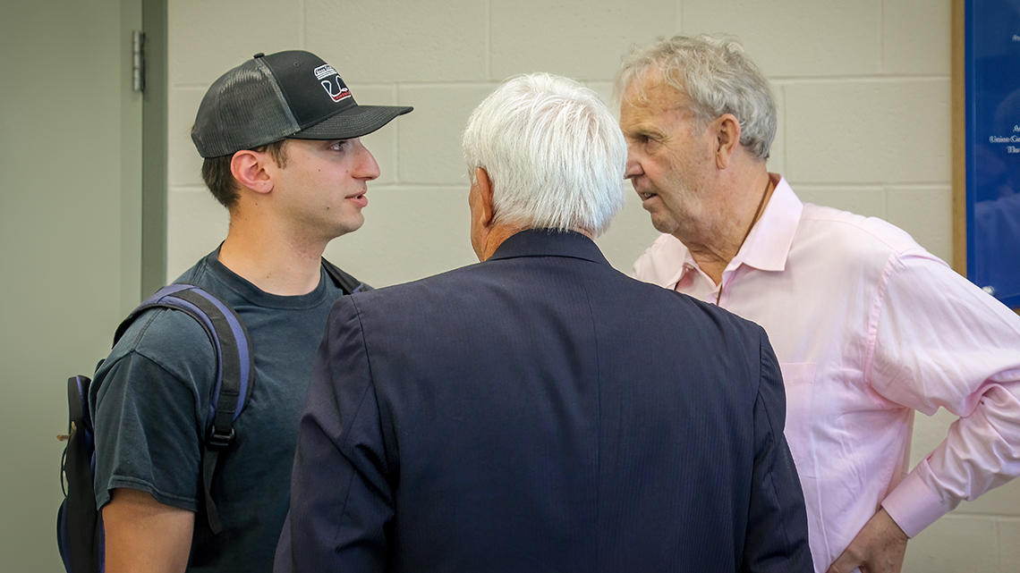 Jimmy Smith and Gary Hill speak with a current student.