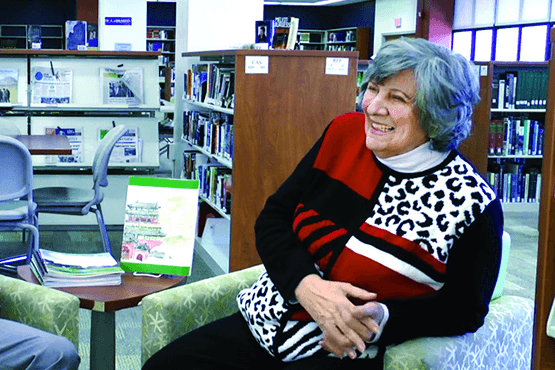 Dr. Constantine seated in the library