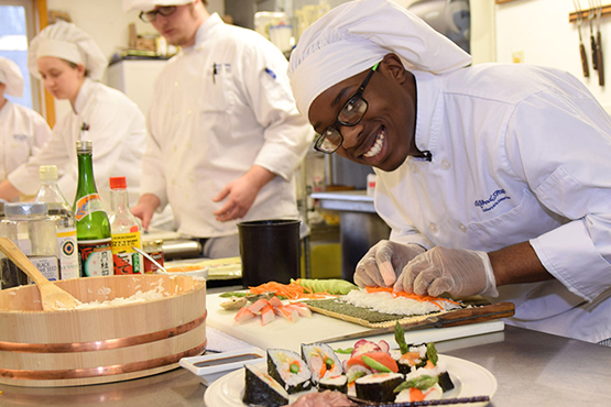 Charles Richards in a kitchen preparing a dish