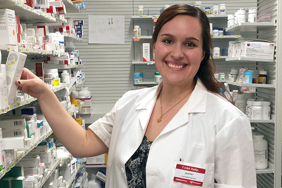 Courtney Cardinal in a pharmacy wearing a lab coat
