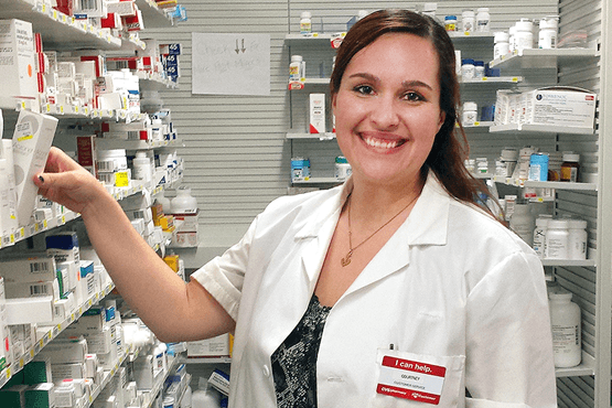 Courtney Cardinal in a pharmacy wearing a lab coat