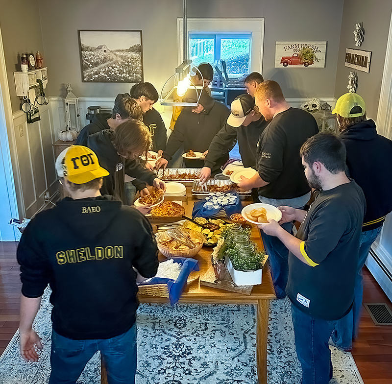 Photo of TKE fraternity over at Dr. Mauro's home for a community meal.
