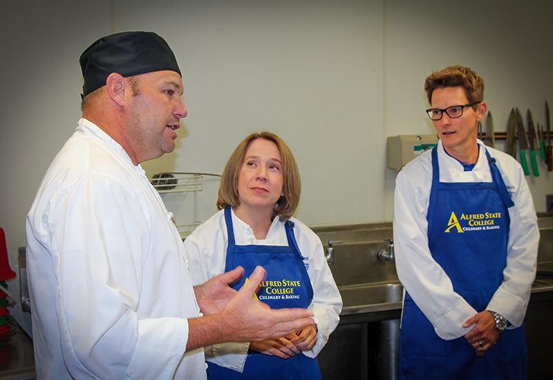 Chef Kevin Scott in a lab activity with VPs Carrie Cokely and Kishan Zuber.