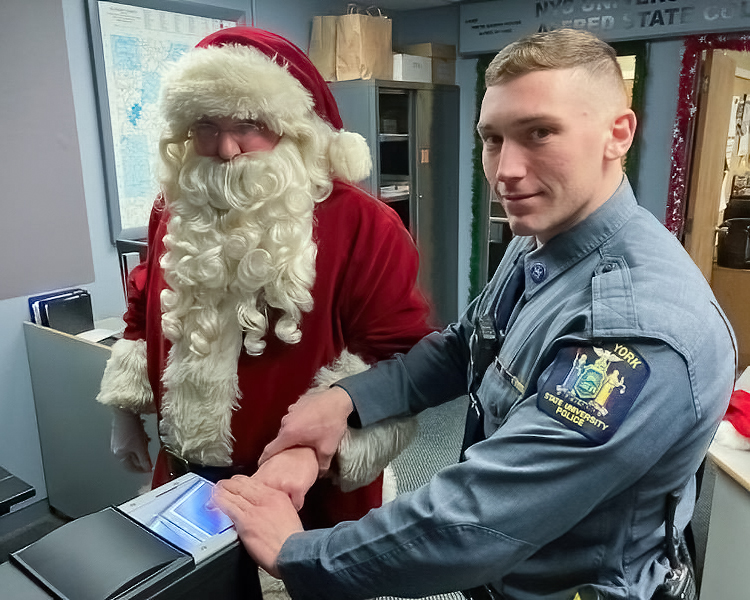 Photo of Officer Mark checking Santa’s ID.