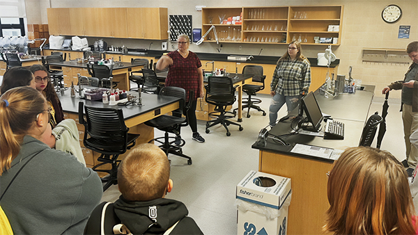 Photo of Holly Young gives Open House visitors a glimpse into the exploration and discovery in labs.