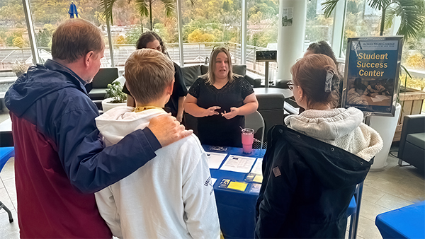 Photo of Tracy Flett reassuring parents and students regarding the many academic support services.