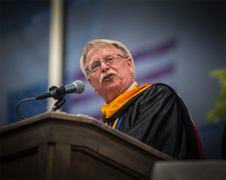 ASC Alum and current accounting professor Charles Neal speaks on Pioneer Pride as he represents the faculty and staff