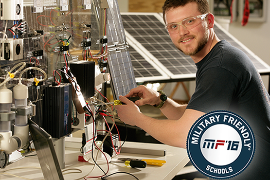 Jordon Williams at the solar lab, Military Friendly Schools logo in corner