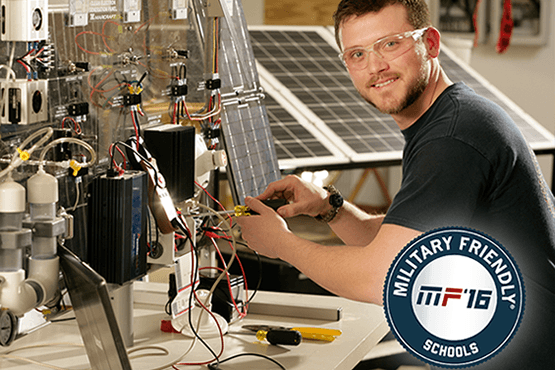 Jordon Williams at the solar lab, Military Friendly Schools 2016 logo in corner