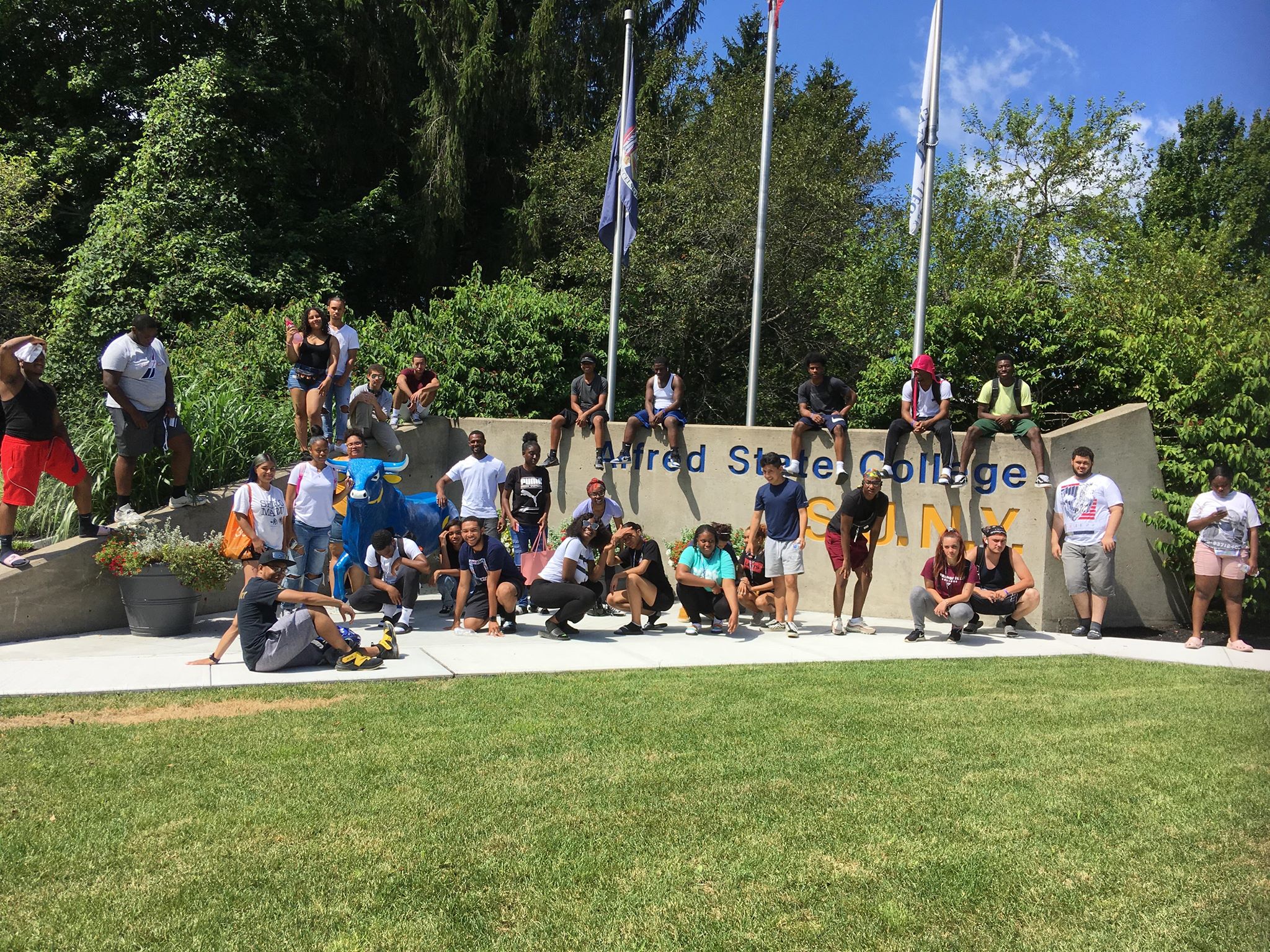 several students standing at main entrance of campus