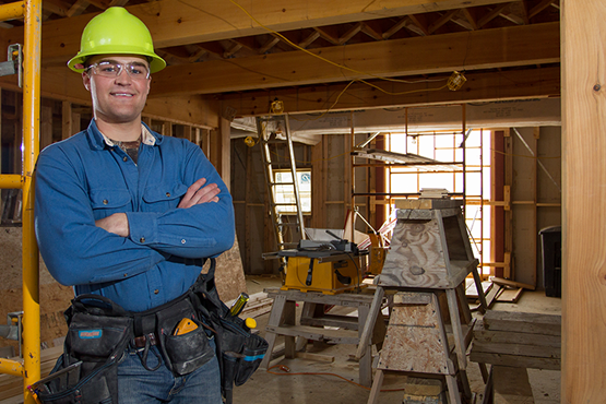 Travis Harvey in a construction zone wearing a hard helmet