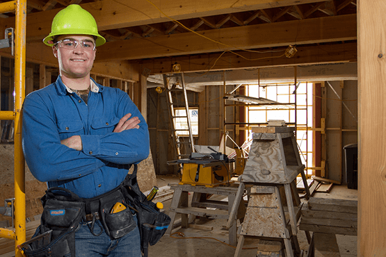 Travis Harvey in a construction zone wearing a hard helmet