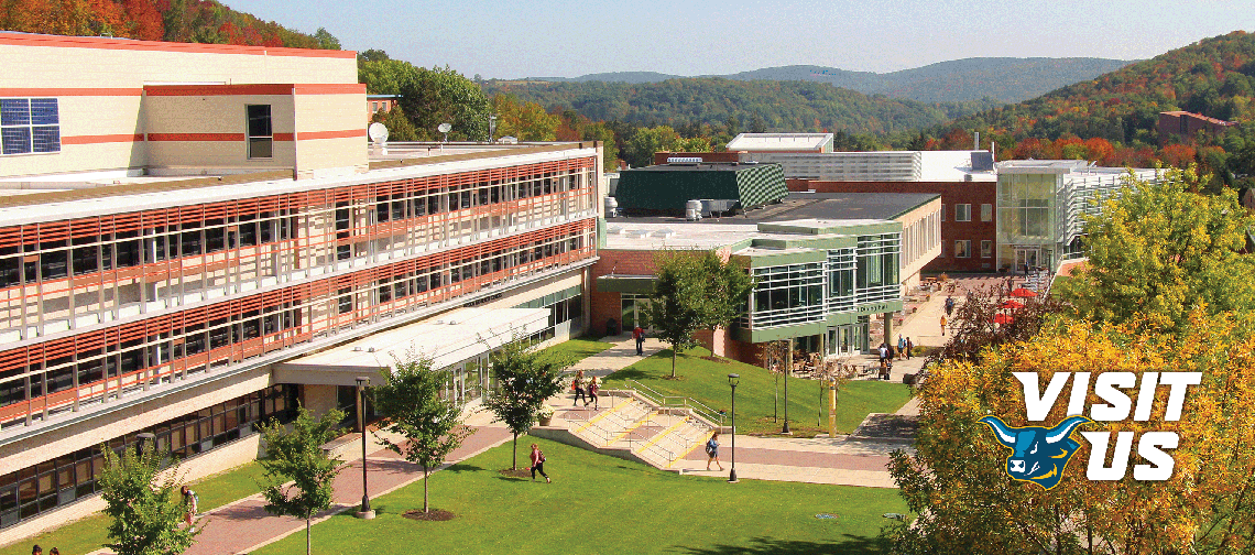 Rooftop view of Alfred State College with rolling hills and fall foliage