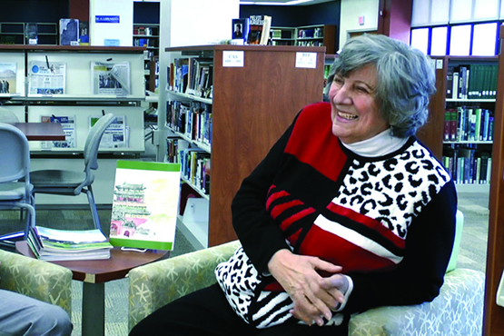 Dr. Constantine seated in the library