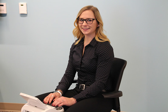 Carissa Kelsch sitting at a stenography machine