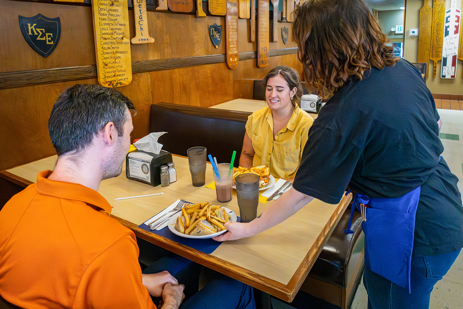 Two people receiving their order at the Collegiate.