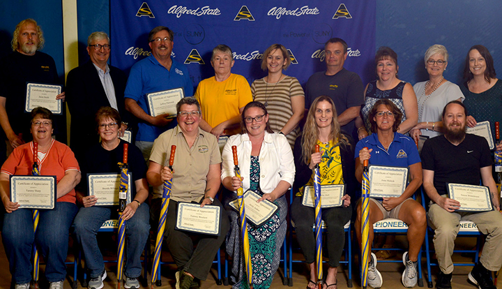 employees holding their umbrellas and certificates