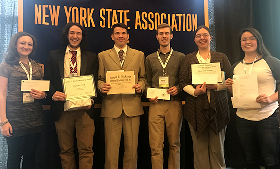 students holding up certificates