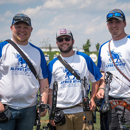 three men wearing blue and white t-shirts and hats