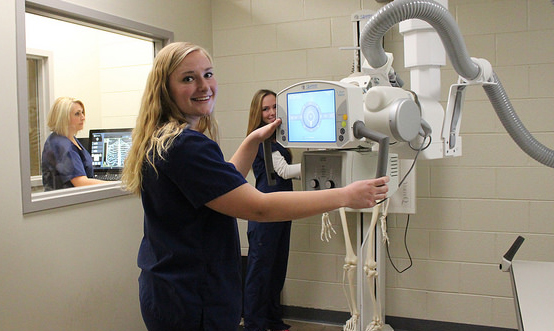 three female student in a lab with medical equipment