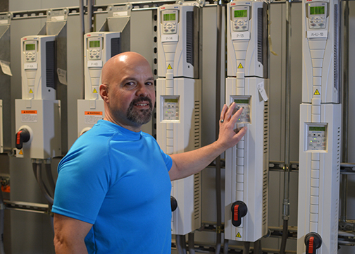 Man poses next to HVAC equipment