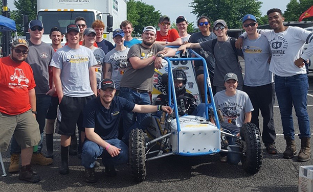 students and the vehicle they designed and fabricated 