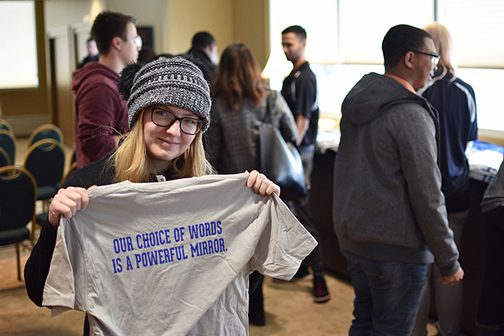 student holding up a t-shirt