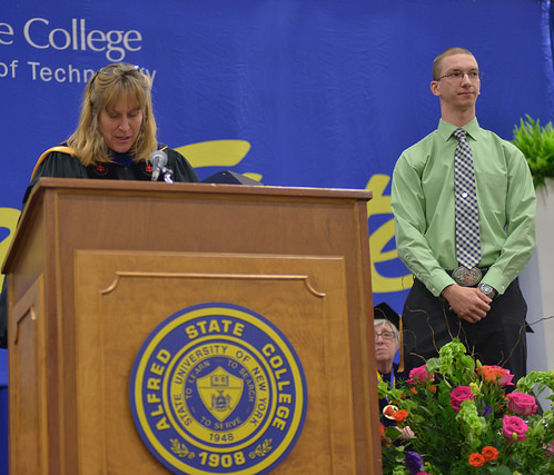 Provost Dr. Kristin Poppo and Brandon Bryniarski on stage