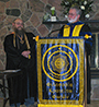 Associate Professor Christopher Tomasi, left, is installed as president of the Alfred State chapter of the Phi Kappa Phi honor societyby Dr. Rick Shale